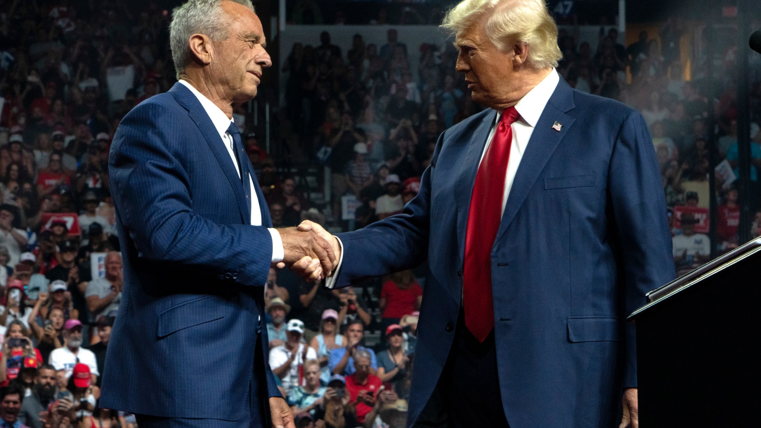 Former Republican presidential candidate Robert F. Kennedy Junior and Republican presidential nominee Donald Trump shake hands during a campaign rally in Glendale, Arizona.