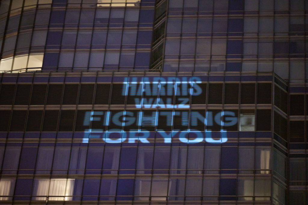 "Harris Walz fighting for you" projected onto the outside of the Trump Hotel before the Democratic National Convention in Chicago.