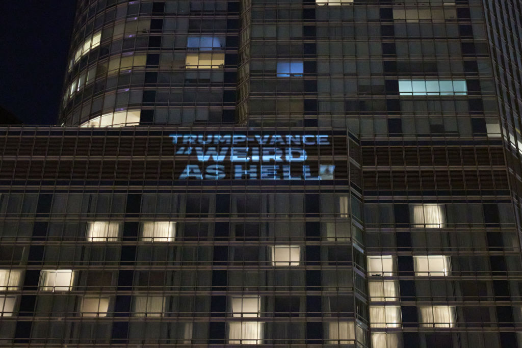 "Trump-Vance weird as hell" projected onto the outside of the Trump Hotel before the Democratic National Convention in Chicago.