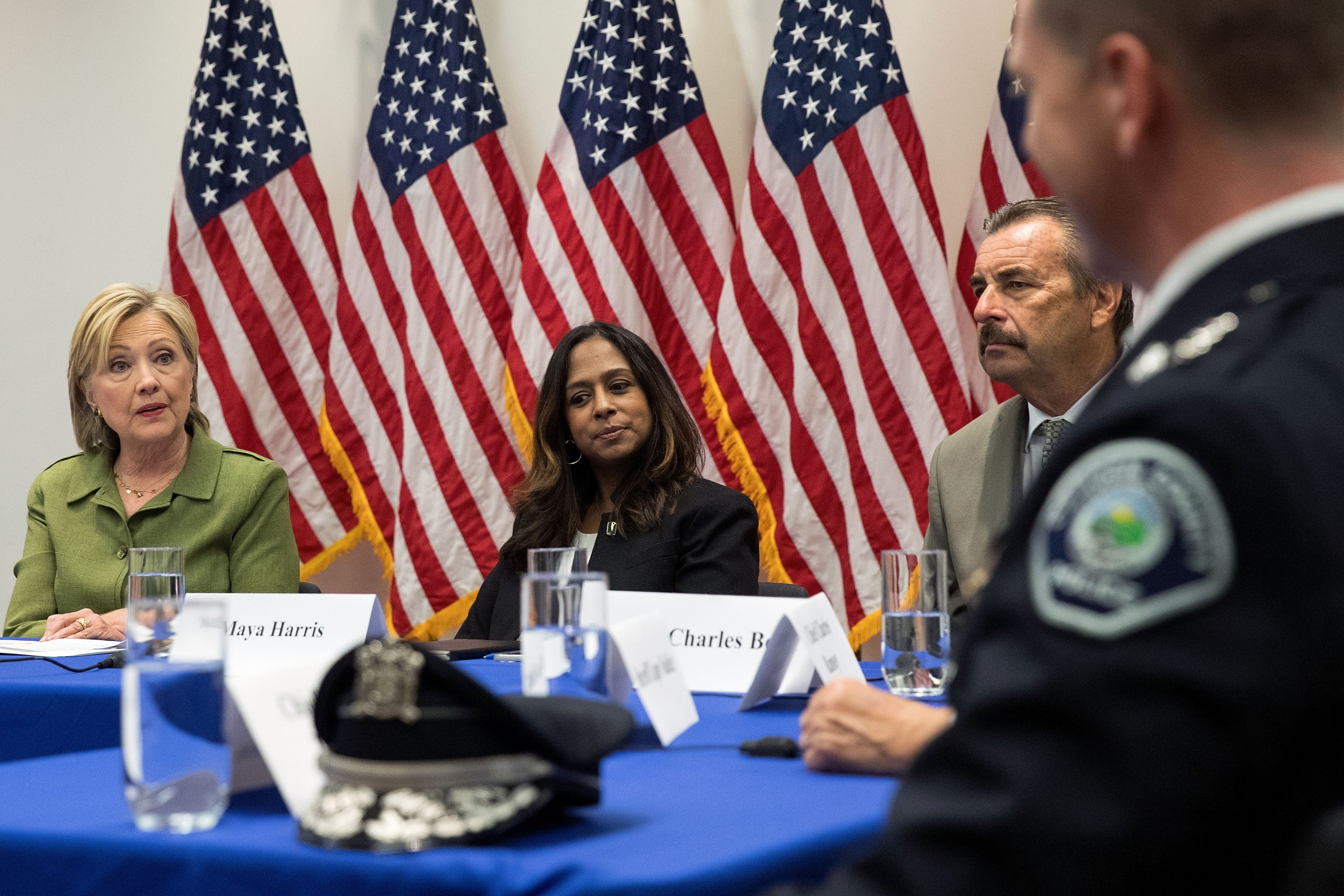 Policy advisor Maya Harris (R) looks on as Democratic presidential candidate Hillary Clinton (L) delivers opening remarks during a meeting with law enforcement officials at the John Jay College of Criminal Justice, August 18, 2016 in New York City.