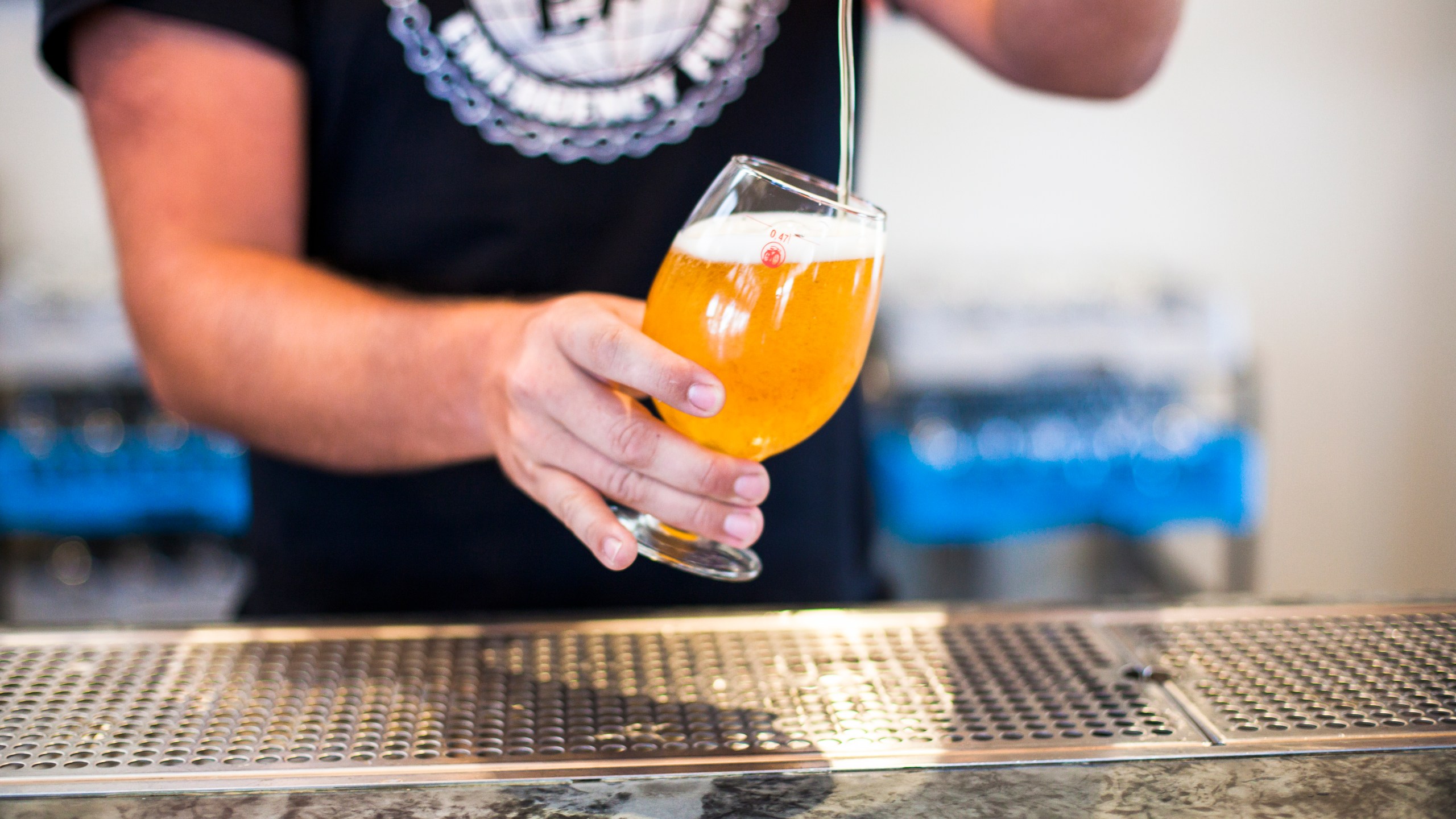 A bartender at New Belgium Brewing Company, pours a beer for a customer at the brewery's liquid center in Asheville, North Carolina.