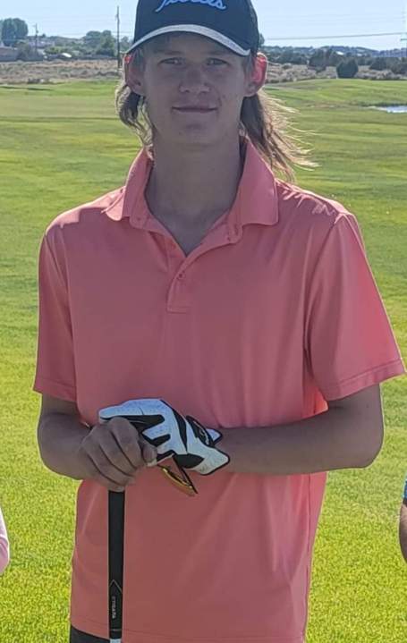 Jarrett Brooks in a pink shirt on a golf course.