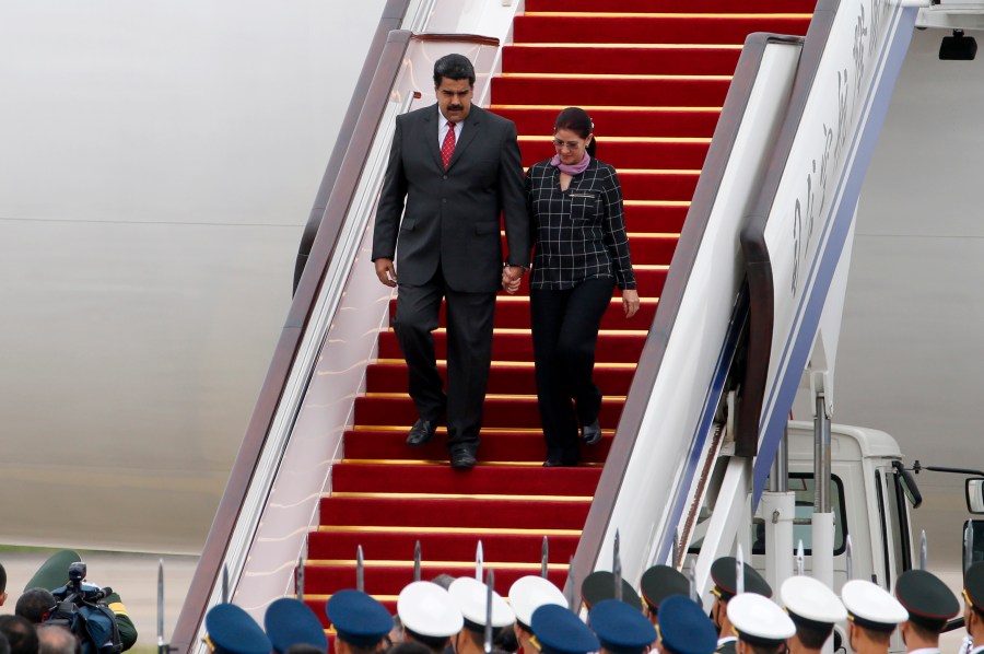 FILE - Venezuela's President Nicolas Maduro, left, and first lady Cilia Flores arrive at Beijing Capital International Airport in Beijing, China, Sept. 1, 2015. (AP Photo/Ng Han Guan, File)