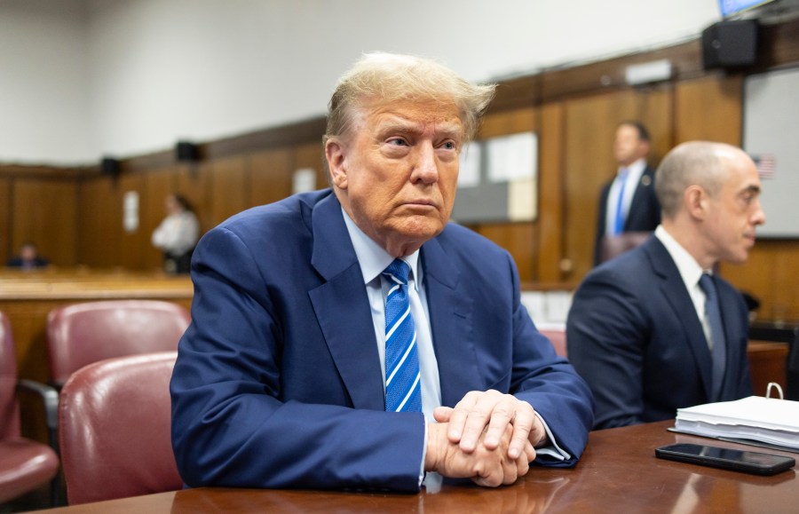 FILE - Former President Donald Trump awaits the start of proceedings on the second day of jury selection at Manhattan criminal court, April 16, 2024, in New York. Manhattan prosecutors are balking at Donald Trump efforts to delay post-trial decisions in his New York hush money criminal case as he seeks to have a federal court intervene and potentially overturn his felony conviction. They lodged their objections in a letter Tuesday to the trial judge but said they could be OK with postponing the ex-president’s Sept. 18 sentencing. (Justin Lane/Pool Photo via AP)