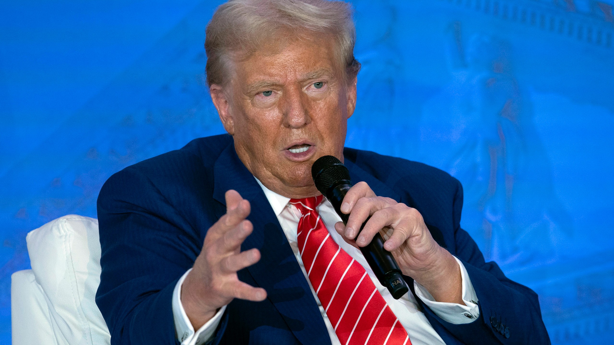 Republican presidential nominee former President Donald Trump speaks with Moms for Liberty co-founder Tiffany Justice during an event at the group's annual convention in Washington, Friday, Aug. 30, 2024. (AP Photo/Jose Luis Magana)