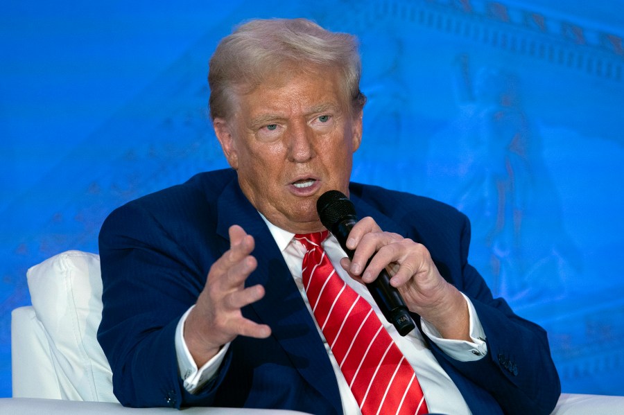 Republican presidential nominee former President Donald Trump speaks with Moms for Liberty co-founder Tiffany Justice during an event at the group's annual convention in Washington, Friday, Aug. 30, 2024. (AP Photo/Jose Luis Magana)