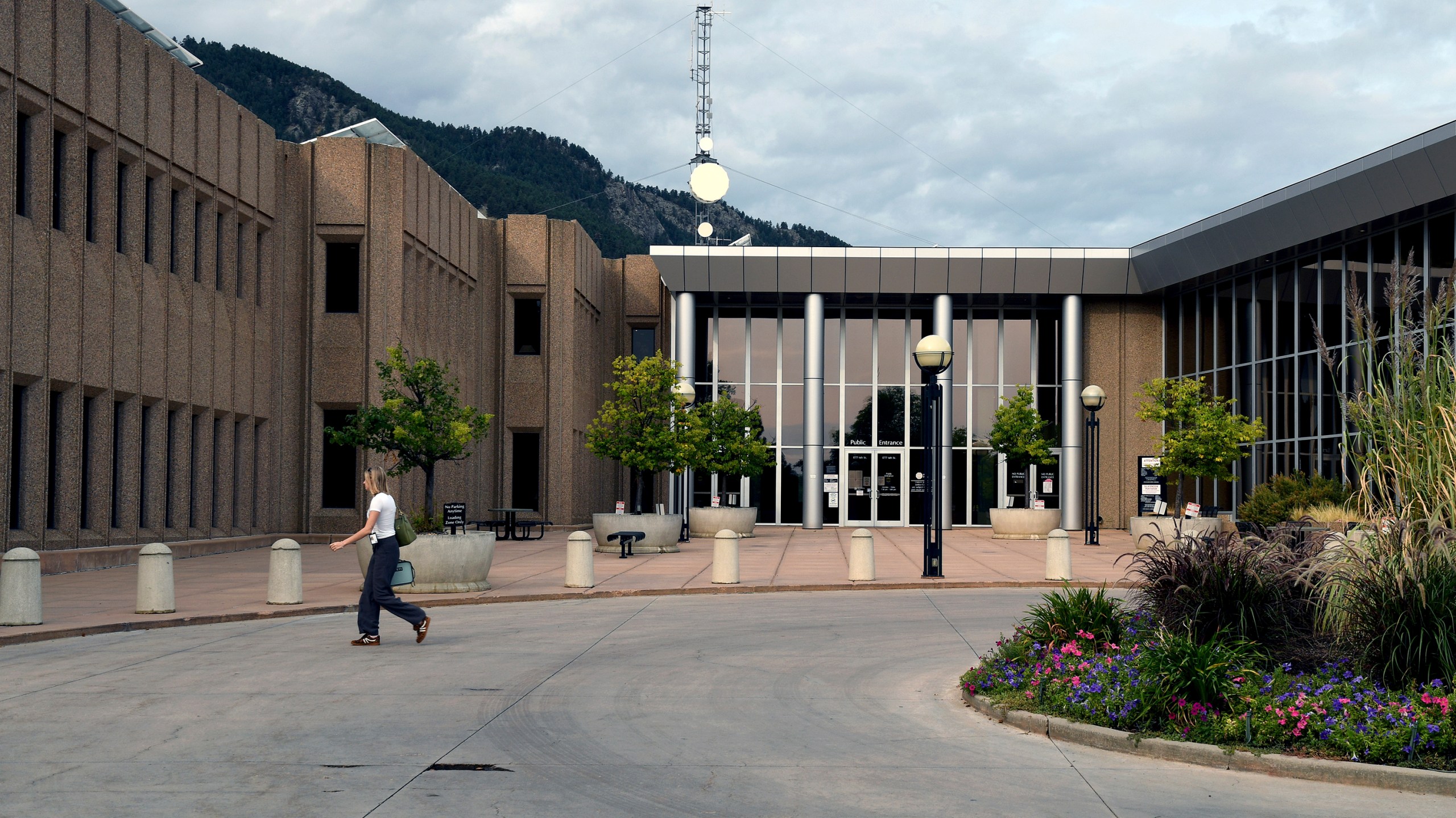 A woman walks in front of the Boulder County Justice Center in Boulder, Colo., on Thursday, Sept. 5, 2024. (AP Photo/Thomas Peipert)