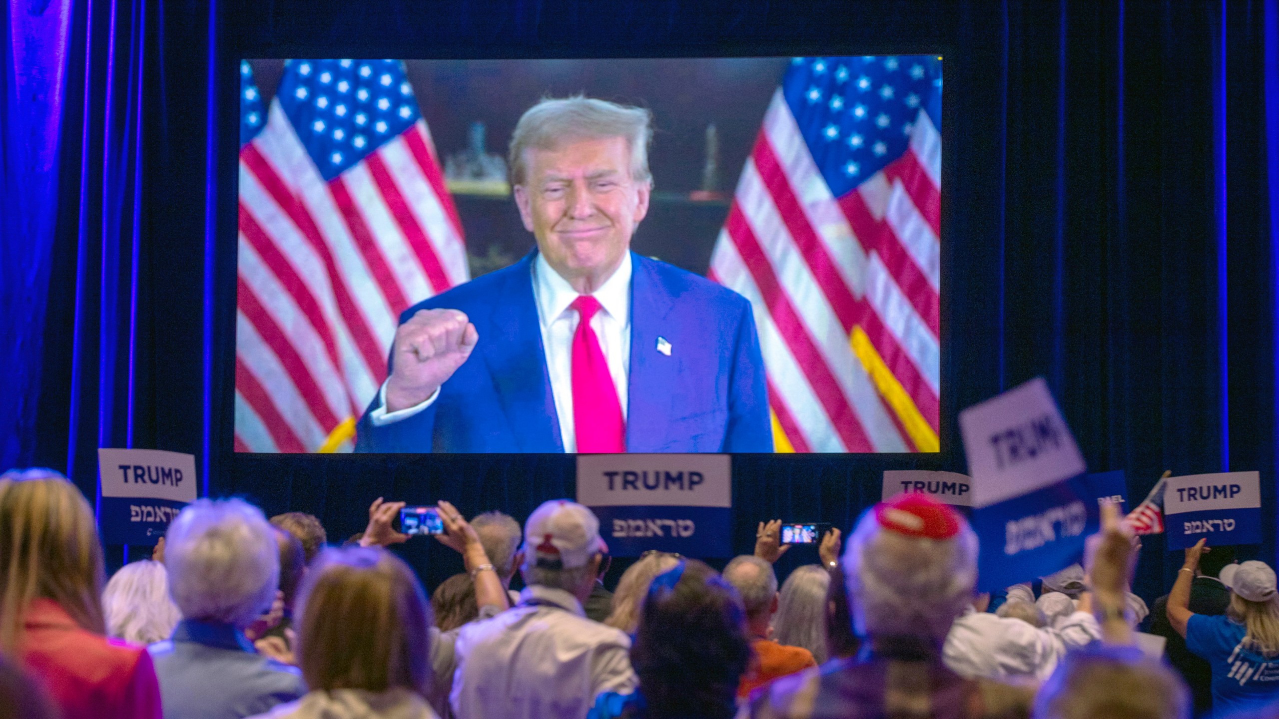 Republican presidential nominee former President Donald Trump appears via a live satellite video feed during the Republican Jewish Coalition annual leadership summit Thursday, Sept. 5, 2024, in Las Vegas. (Steve Marcus/Las Vegas Sun via AP)