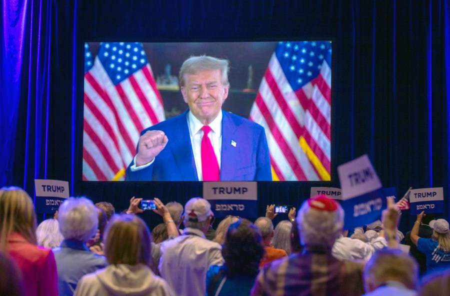 Republican presidential nominee former President Donald Trump appears via a live satellite video feed during the Republican Jewish Coalition annual leadership summit Thursday, Sept. 5, 2024, in Las Vegas. (Steve Marcus/Las Vegas Sun via AP)