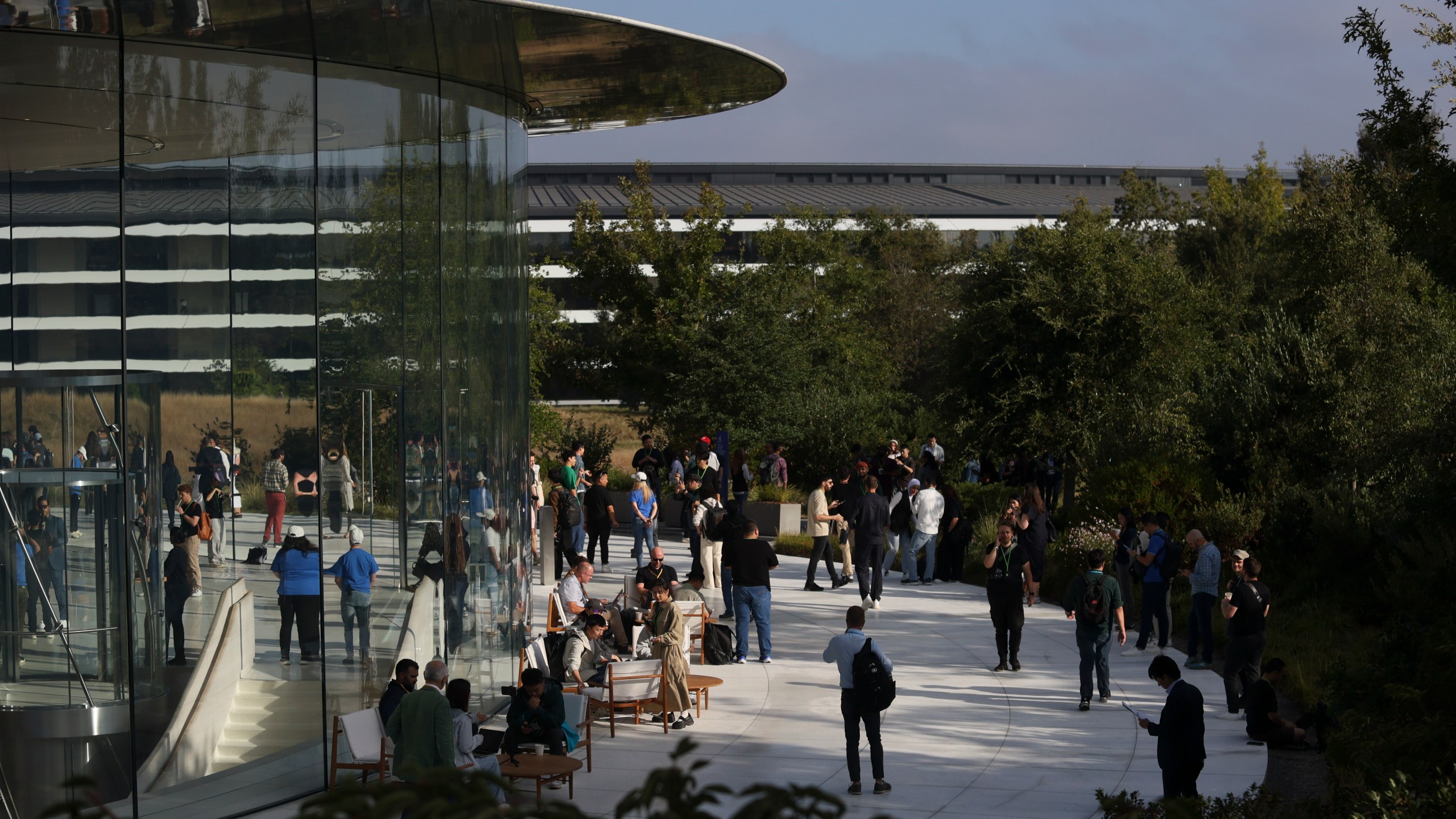 Attendees wait inside and outside the Steve Jobs Theater before an announcement of new products at Apple headquarters Monday, Sept. 9, 2024, in Cupertino, Calif. (AP Photo/Juliana Yamada)