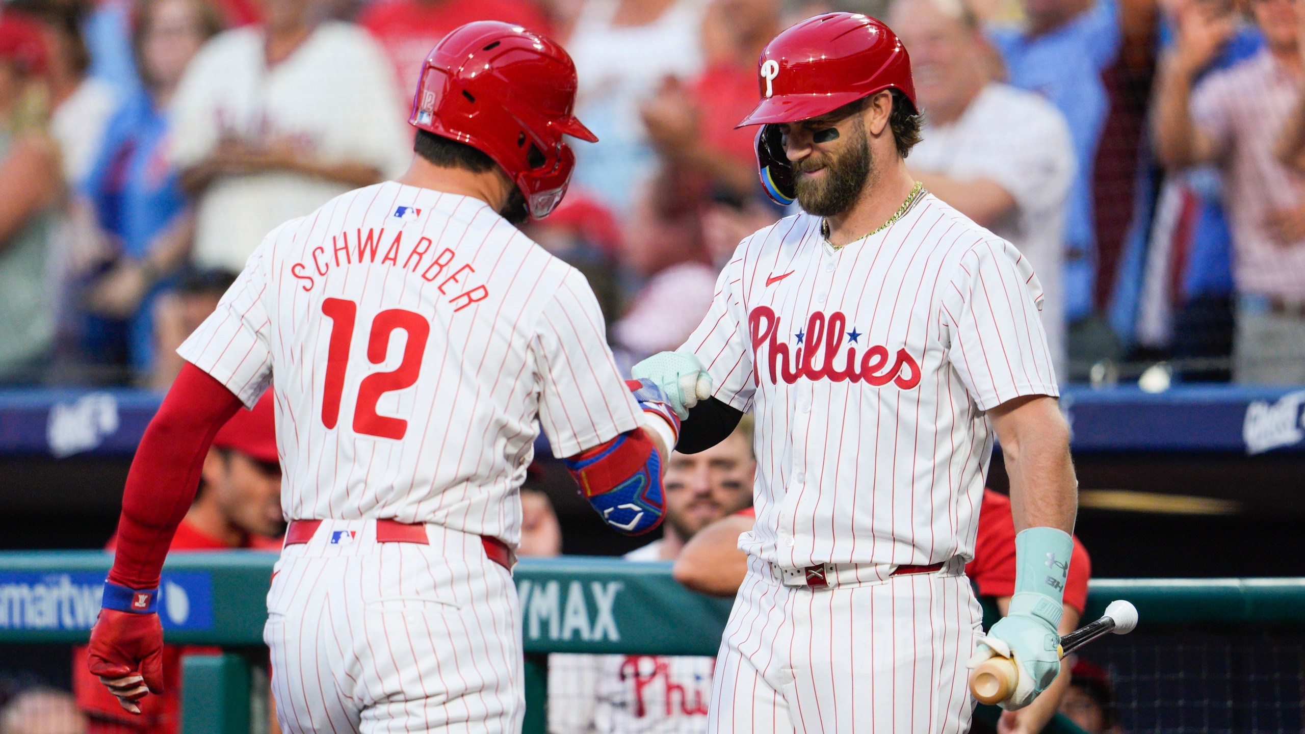 Philadelphia Phillies' Kyle Schwarber (12) celebrates his solo home run with Bryce Harper during the first inning of a baseball game against the Tampa Bay Rays, Tuesday, Sept. 10, 2024, in Philadelphia. (AP Photo/Derik Hamilton)