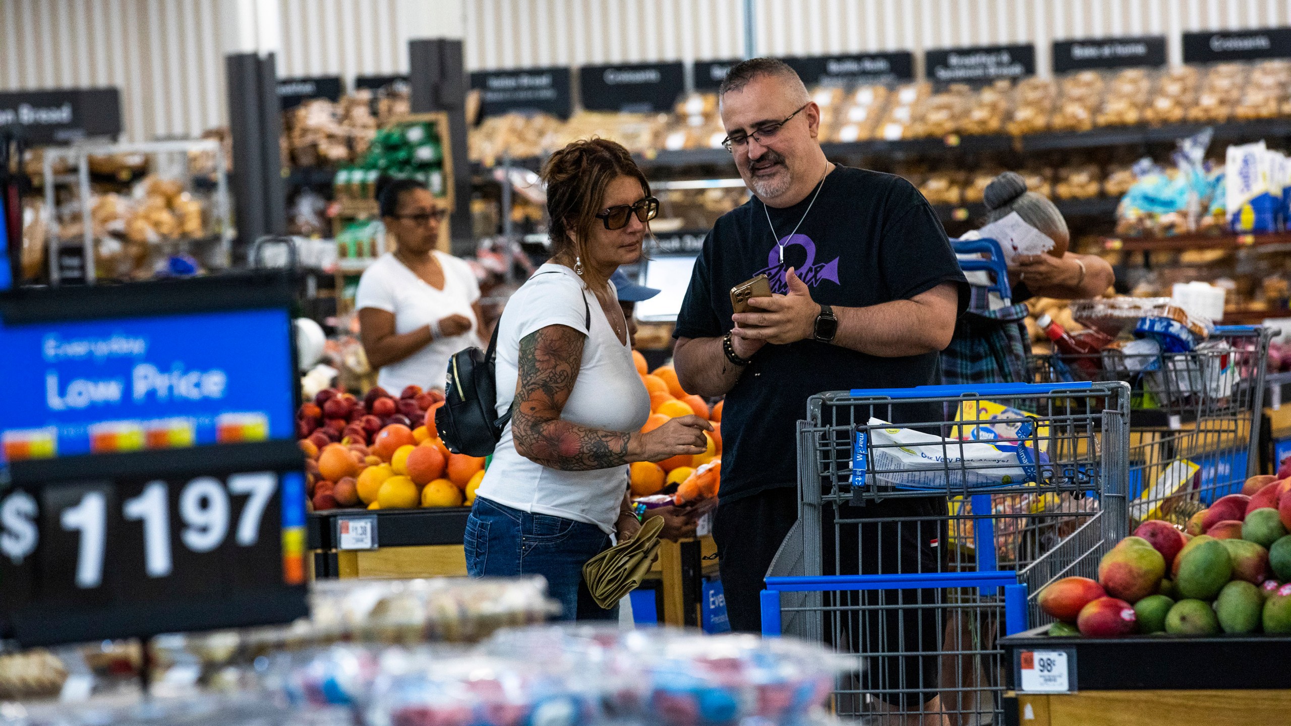 FILE - Shoppers pause in the produce section at a Walmart Superstore in Secaucus, New Jersey, July 11, 2024. (AP Photo/Eduardo Munoz Alvarez, File)