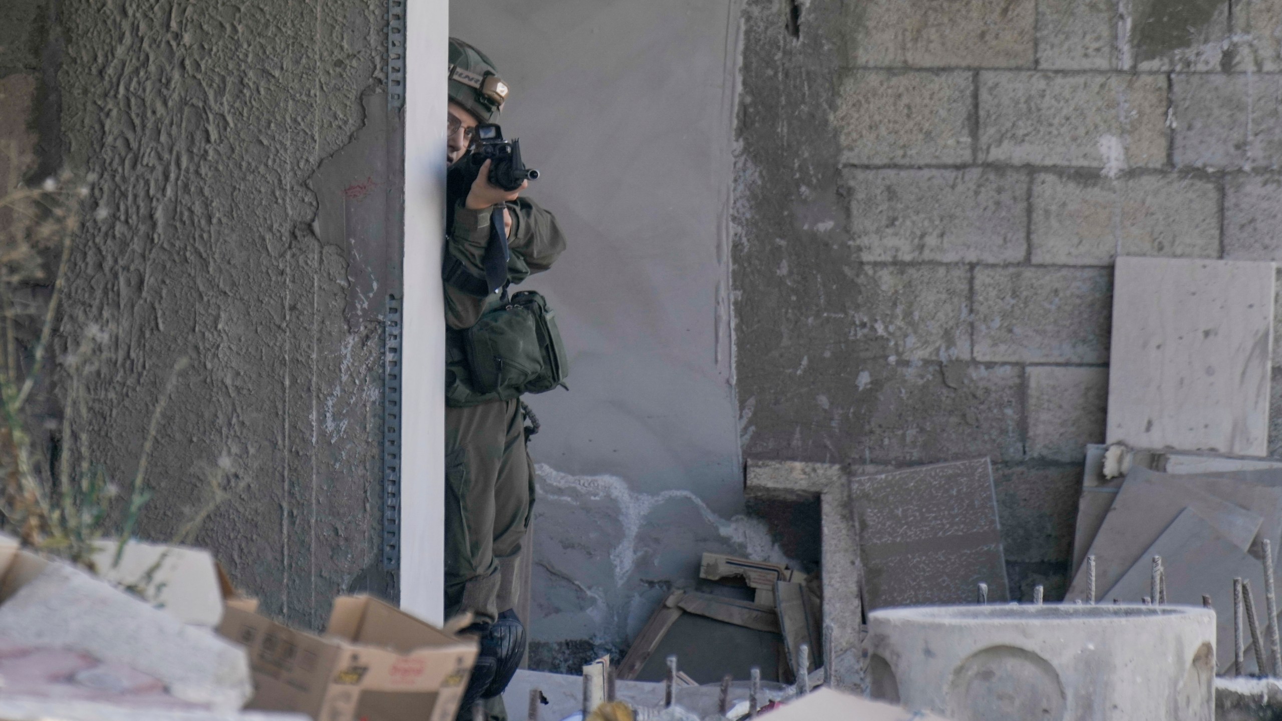 An Israeli soldier aims her rifle during an army raid in Tubas, West Bank, on Wednesday, Sept. 11, 2024. (AP Photo/Majdi Mohammed)