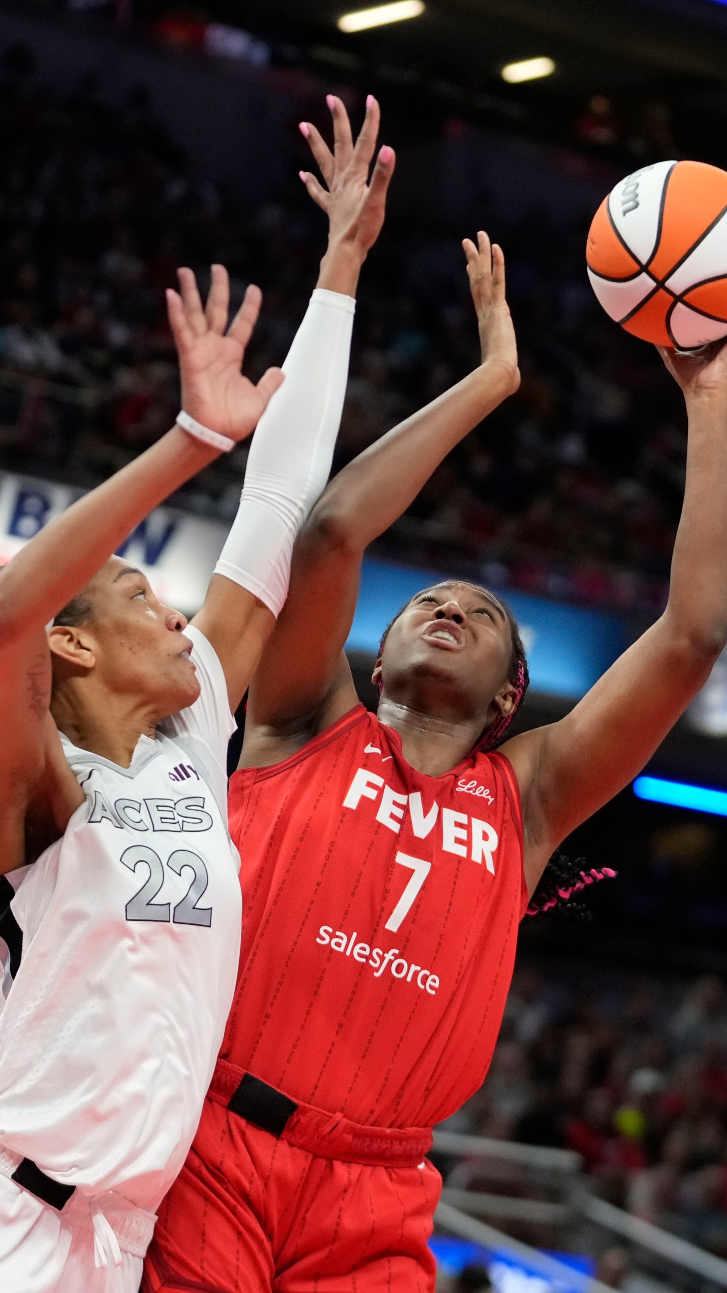 Indiana Fever's Aliyah Boston (7) shoots over Las Vegas Aces' A'ja Wilson (22) during the first half of a WNBA basketball game, Wednesday, Sept. 11, 2024, in Indianapolis. (AP Photo/Darron Cummings)