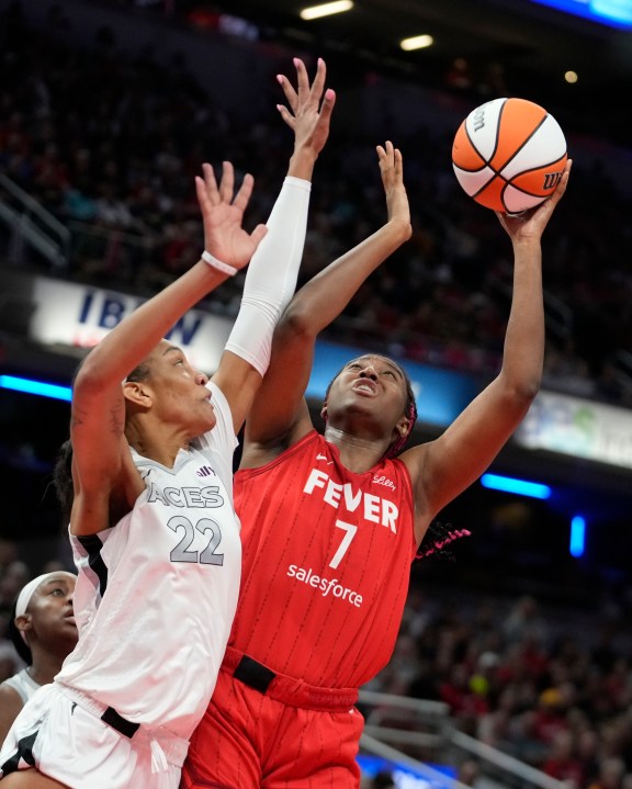 Indiana Fever's Aliyah Boston (7) shoots over Las Vegas Aces' A'ja Wilson (22) during the first half of a WNBA basketball game, Wednesday, Sept. 11, 2024, in Indianapolis. (AP Photo/Darron Cummings)