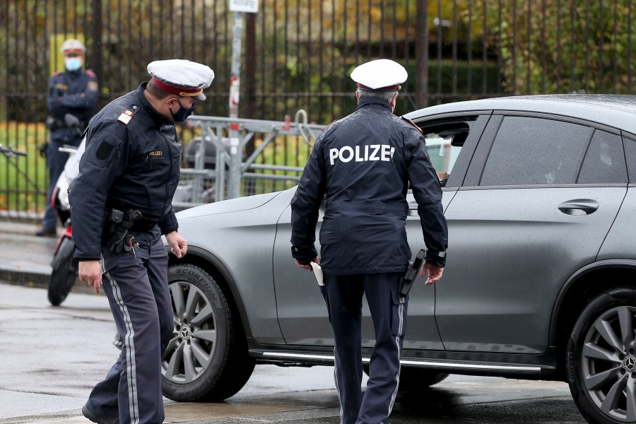 FILE - Police officers check a car in downtown Vienna, Austria, Friday, Oct. 30, 2020. (AP Photo/Ronald Zak, File)