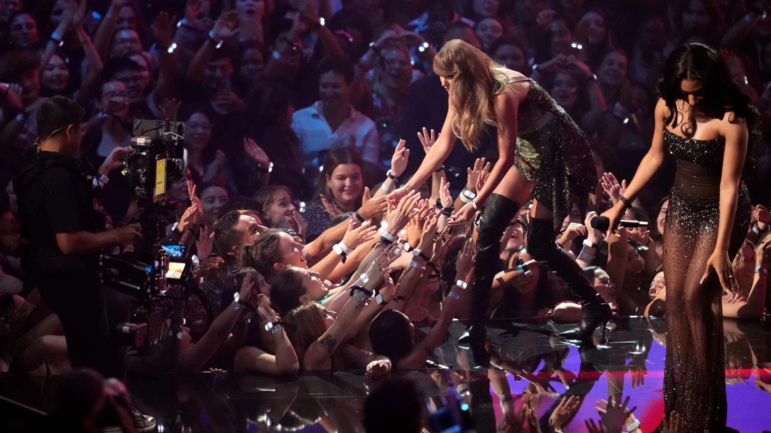 Taylor Swift, left, accepts the video of the year for "Fortnight" from Megan Thee Stallion during the MTV Video Music Awards on Wednesday, Sept. 11, 2024, at UBS Arena in Elmont, N.Y. (Photo by Charles Sykes/Invision/AP)