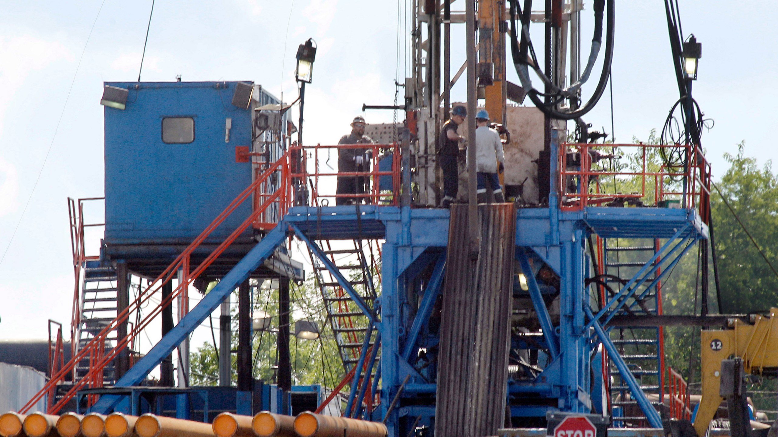 FILE - A crew works on a gas drilling rig at a well site for shale based natural gas in Zelienople, Pa. June 25, 2012. (AP Photo/Keith Srakocic, File)