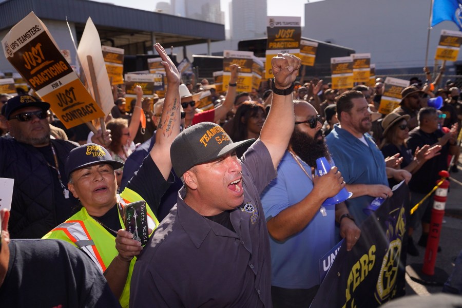 FILE - Teamsters and workers hold a rally in downtown Los Angeles, July 19, 2023, as a deadline neared in negotiations between the union and United Parcel Service. (AP Photo/Damian Dovarganes)