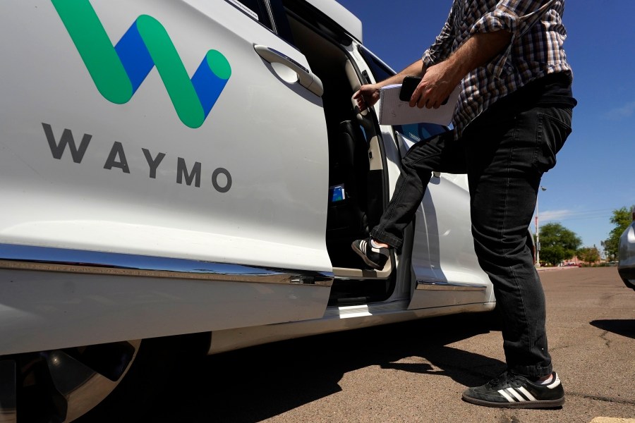 FILE - A Waymo minivan arrives to pick up passengers for an autonomous vehicle ride, Wednesday, April 7, 2021, in Mesa, Ariz. (AP Photo/Ross D. Franklin, File)