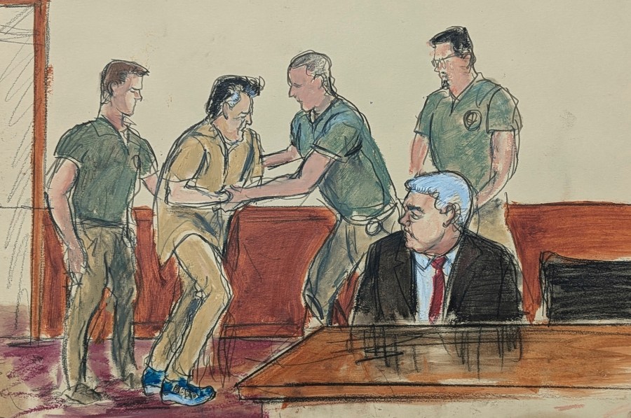 In this courtroom sketch, Ismael “El Mayo” Zambada, second left, assisted by the U.S. Marshals, is led into the courtroom as his defense attorney Frank Perez, seated right, watches in federal court, Friday, Sept. 13, 2024, in the Brooklyn borough of New York,. (Elizabeth Williams via AP)