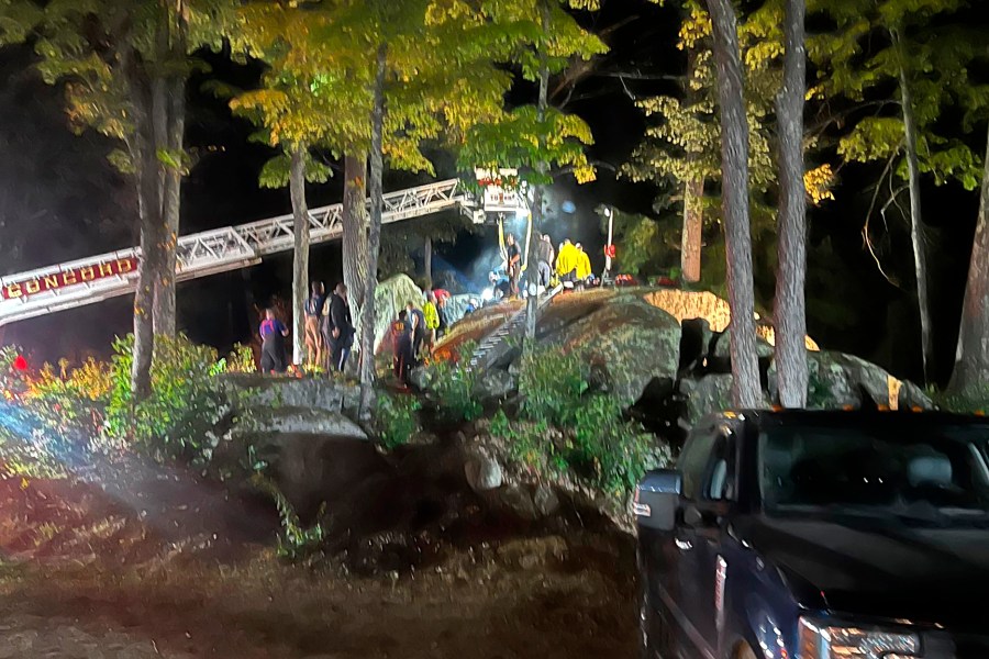 This Sunday, Sept. 15, 2024 photo provided by the Hillsborough Fire Department shows first responders at the scene of a rescue for a child who became wedged between two boulders, in Windsor, N.H. (Hillsborough Fire Department via AP)