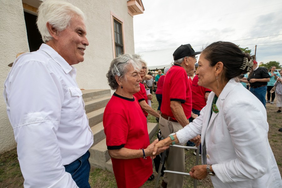 Secretary of the Interior Deb Haaland, right, congratulates alumni Betty Nuñez Aguirre, center, and Tony Cano during the inauguration of Blackwell School as the newest National Historic Site in Marfa, Texas, Saturday, Sept. 14, 2024. (AP Photo/Andres Leighton)