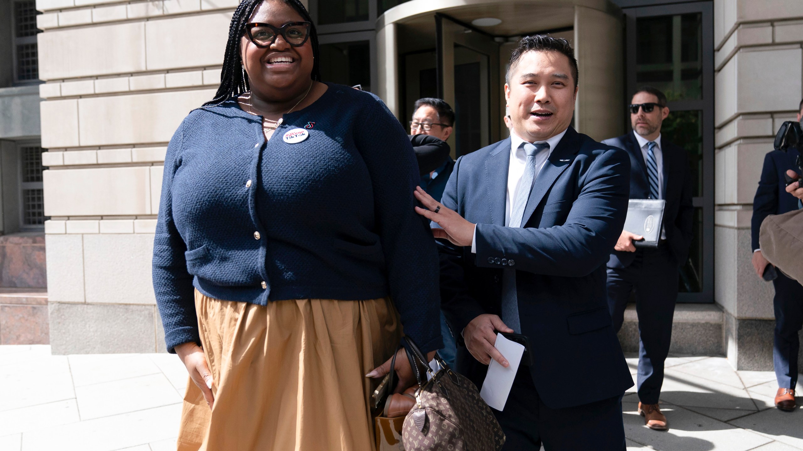 TikTok content creators Talia Cadet, left, and Paul Tran leave the federal courthouse in Washington, Monday, Sept. 16, 2024, after a hearing on TikTok's lawsuit against the federal government. (AP Photo/Jose Luis Magana)