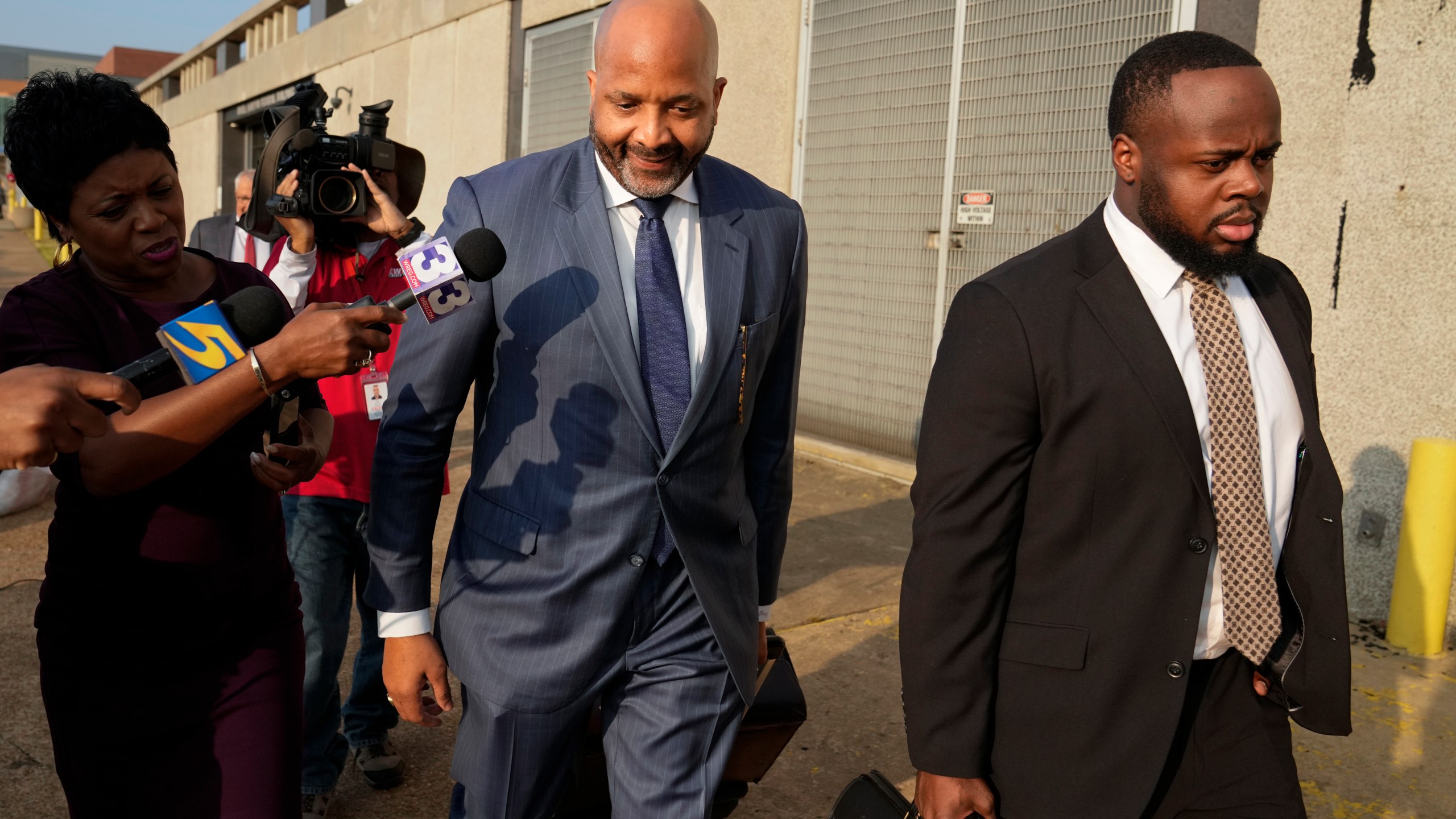 Attorney John Keith Perry, center, leaves the federal courthouse with his client former Memphis police officer Tadarrius Bean after the first day of jury selection of the trial in the Tyre Nichols case Monday, Sept. 9, 2024, in Memphis, Tenn. (AP Photo/George Walker IV)