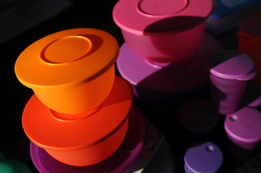 FILE - Colorful Tupperware products are seen in Bellflower, Calif. on Aug. 5, 2011. (AP Photo/Garrett Cheen, File)