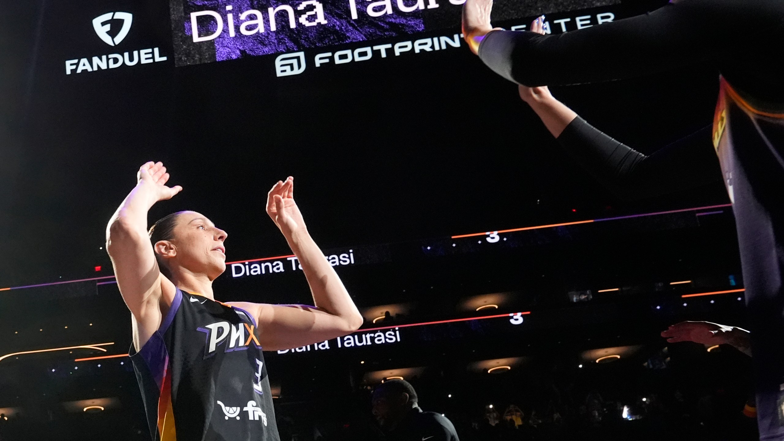 Phoenix Mercury guard Diana Taurasi, left, is greeted by Mercury guard Sophie Cunningham during player introductions prior to a WNBA basketball game against the Seattle Storm, Thursday, Sept. 19, 2024, in Phoenix. (AP Photo/Ross D. Franklin)