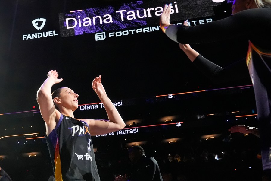 Phoenix Mercury guard Diana Taurasi, left, is greeted by Mercury guard Sophie Cunningham during player introductions prior to a WNBA basketball game against the Seattle Storm, Thursday, Sept. 19, 2024, in Phoenix. (AP Photo/Ross D. Franklin)