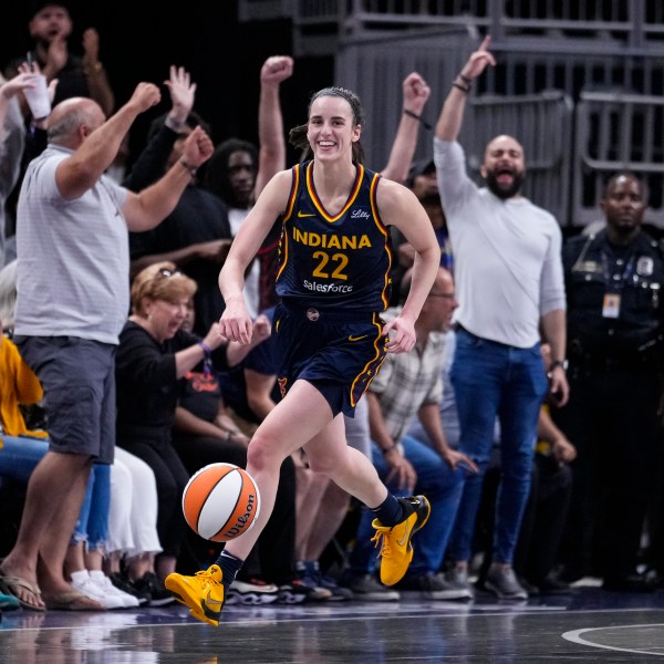 Indiana Fever guard Caitlin Clark (22) smiles after gabbing her tenth rebound in the closing seconds of a games against the Los Angeles Sparks in the second half of a WNBA basketball game in Indianapolis, Wednesday, Sept. 4, 2024. The rebound gave Clark a triple-double for the game. (AP Photo/Michael Conroy)