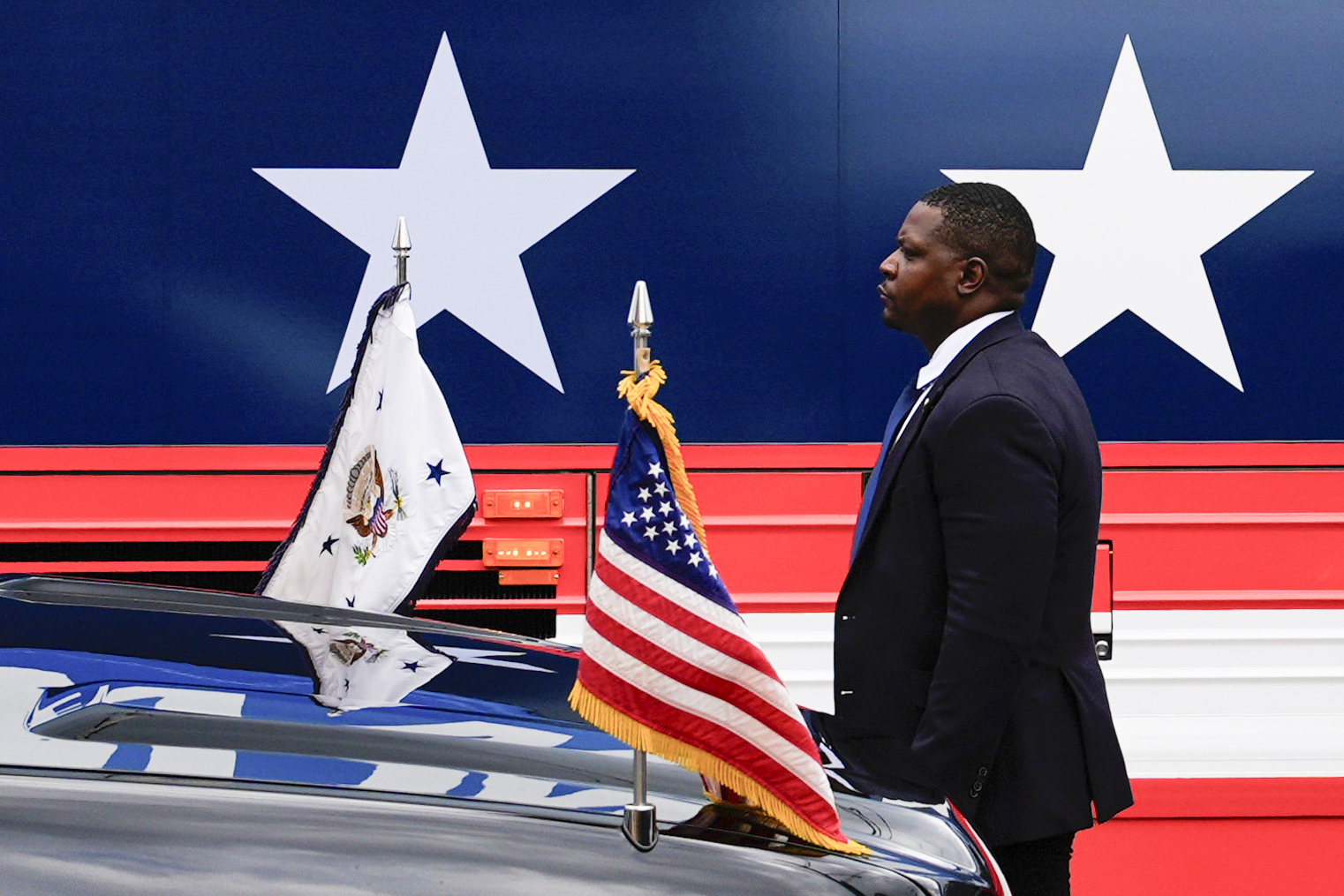 FILE - A U.S. Secret Service agent stands watch outside a campaign bus for Democratic presidential nominee Vice President Kamala Harris and her running mate Minnesota Gov. Tim Walz, Aug. 18, 2024, in Rochester, Pa. (AP Photo/Julia Nikhinson, File)