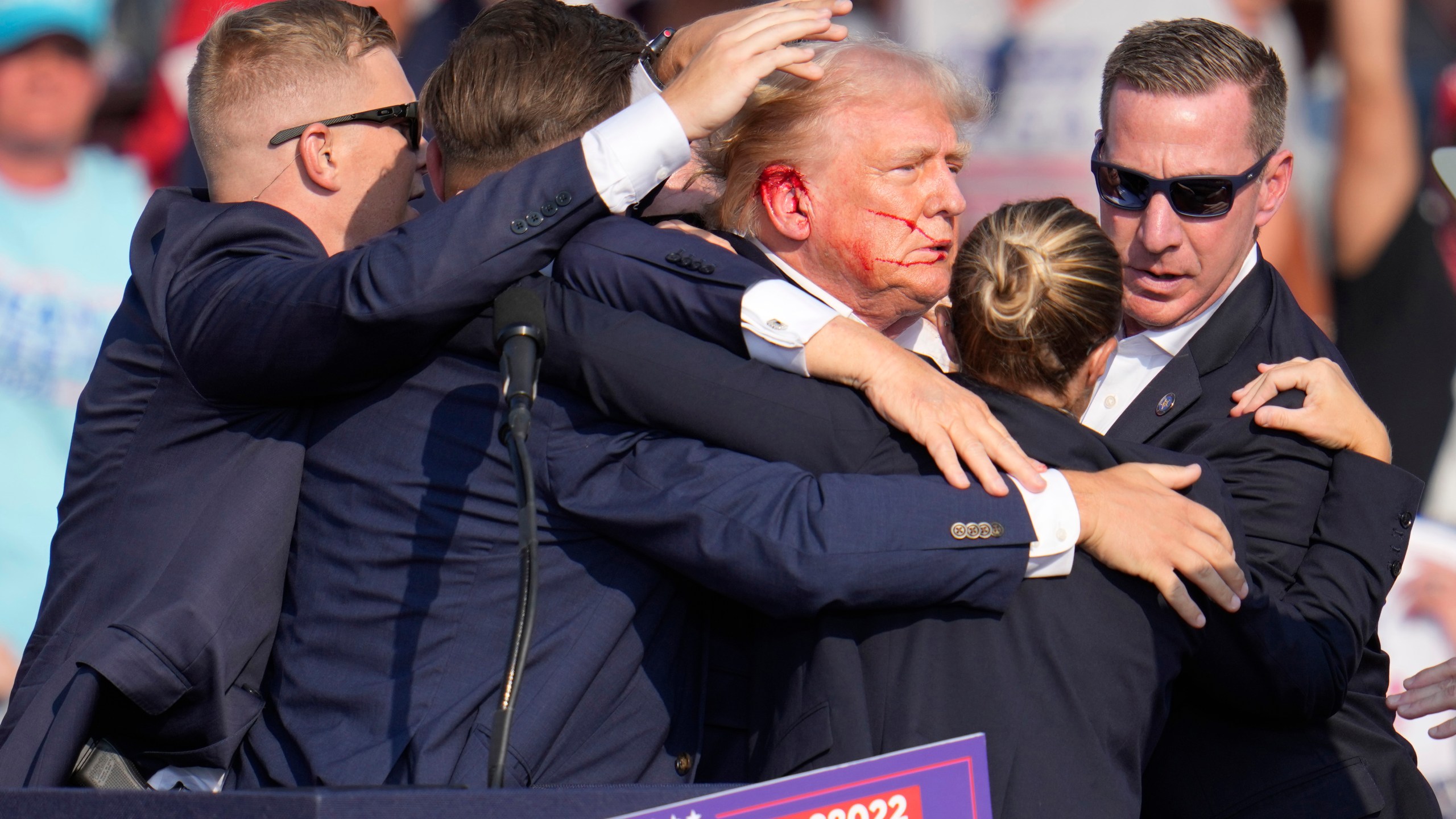 FILE - Republican presidential candidate former President Donald Trump is surrounded by U.S. Secret Service agents as he is helped off the stage at a campaign rally in Butler, Pa., July 13, 2024. (AP Photo/Gene J. Puskar, File)