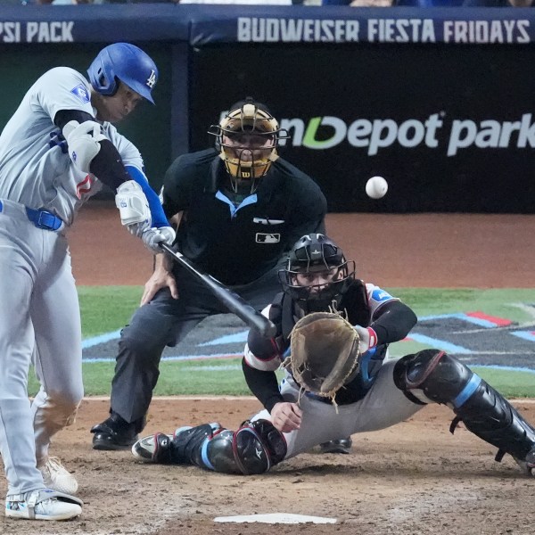 Los Angeles Dodgers' Shohei Ohtani (17) hits a home run scoring Andy Pages, during the seventh inning of a baseball game against the Miami Marlins, Thursday, Sept. 19, 2024, in Miami. (AP Photo/Wilfredo Lee)