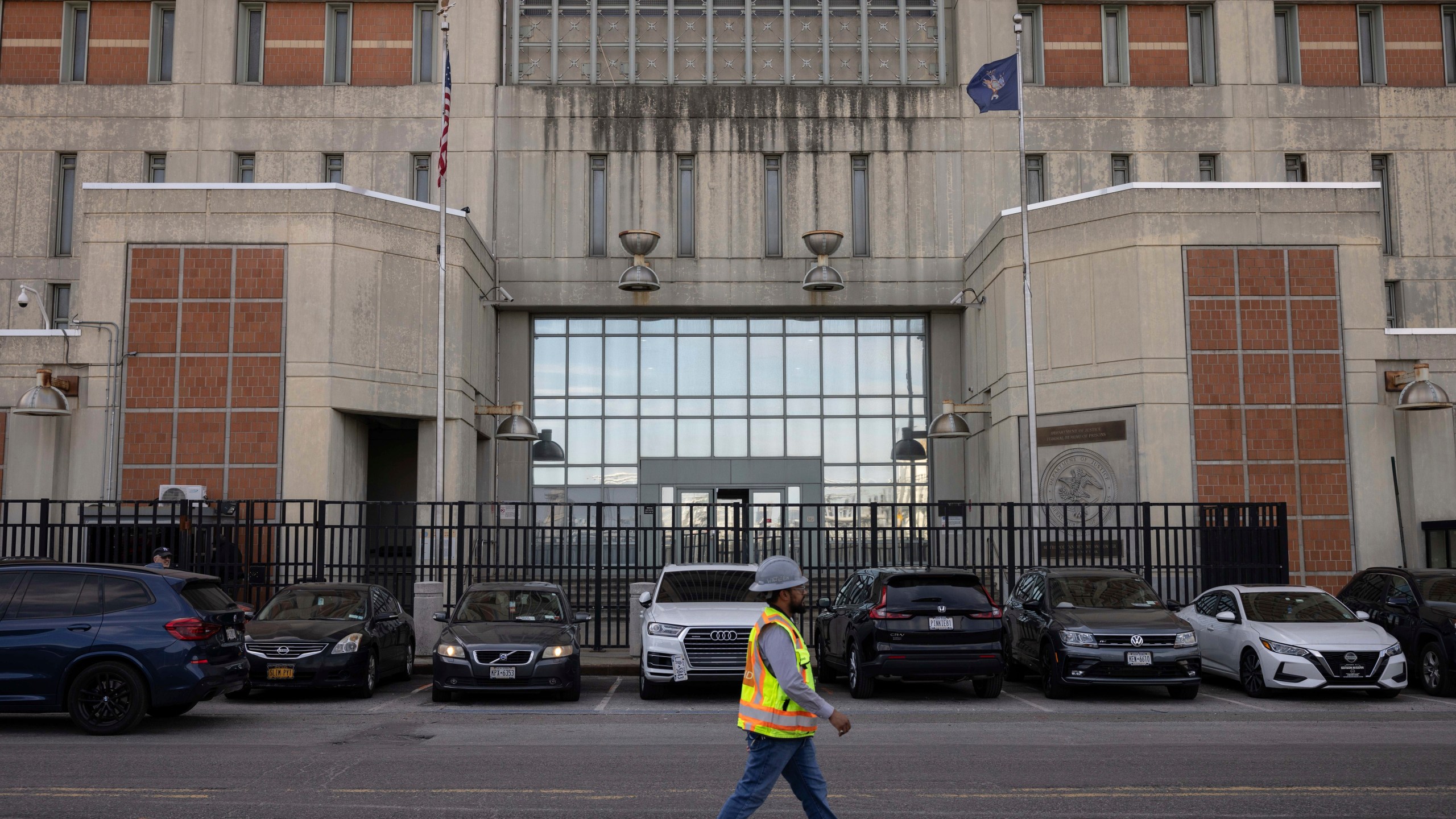 A construction worker walks past the Metropolitan Detention Center in the Sunset Park neighborhood of the Brooklyn borough of New York, Thursday, Sept. 19, 2024. (AP Photo/Yuki Iwamura)