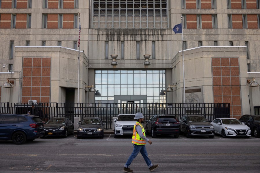 A construction worker walks past the Metropolitan Detention Center in the Sunset Park neighborhood of the Brooklyn borough of New York, Thursday, Sept. 19, 2024. (AP Photo/Yuki Iwamura)