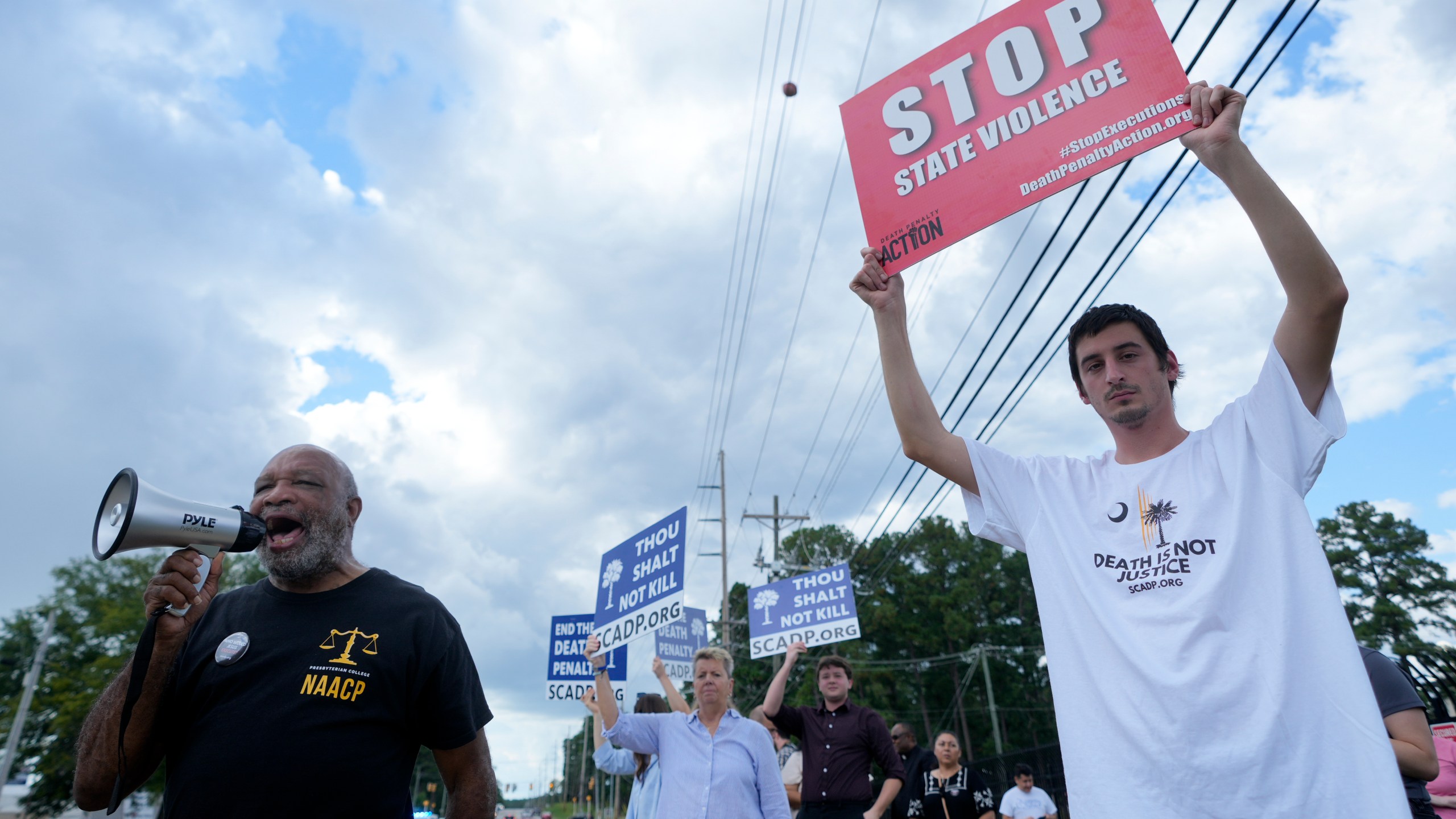 Jesse Motte, right, protests the planned execution of Freddie Eugene Owens, 46, on Friday, Sept. 20, 2024, in Columbia, S.C. Owens is set to be the first person to be executed in South Carolina in 13 years. (AP Photo/Chris Carlson)