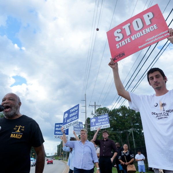 Jesse Motte, right, protests the planned execution of Freddie Eugene Owens, 46, on Friday, Sept. 20, 2024, in Columbia, S.C. Owens is set to be the first person to be executed in South Carolina in 13 years. (AP Photo/Chris Carlson)