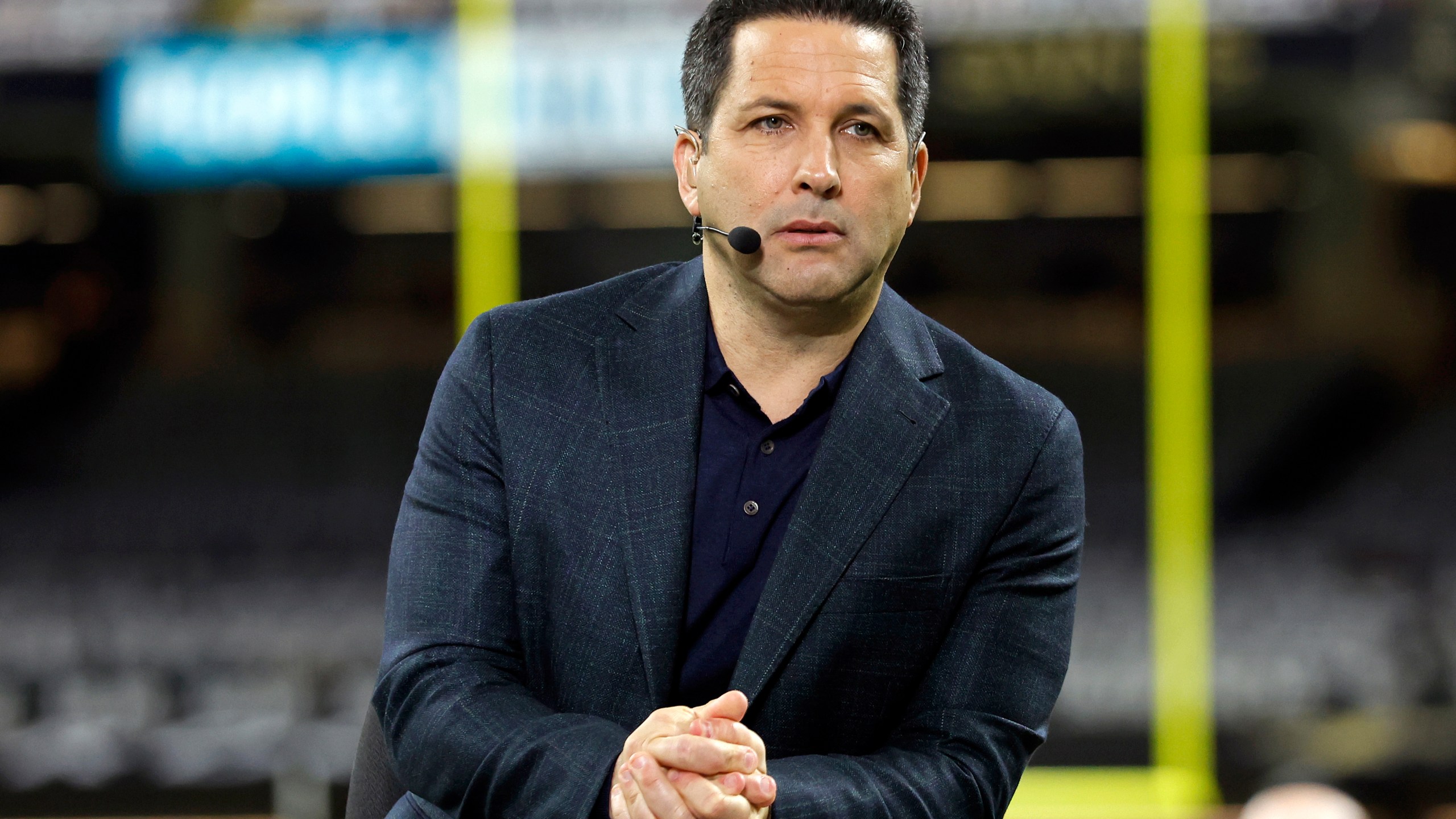 FILE - ESPN Monday Night Football commentator Adam Schefter is seen on set before an NFL football game between the New Orleans Saints and the Baltimore Ravens, Monday, Nov. 7, 2022, in New Orleans. (AP Photo/Tyler Kaufman, File)