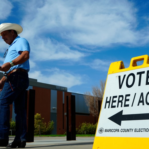 FILE - A voter walks to a voting precinct prior to casting his ballot in the state's primary election, Tuesday, July 30, 2024, in El Mirage, Ariz. (AP Photo/Ross D. Franklin, File)