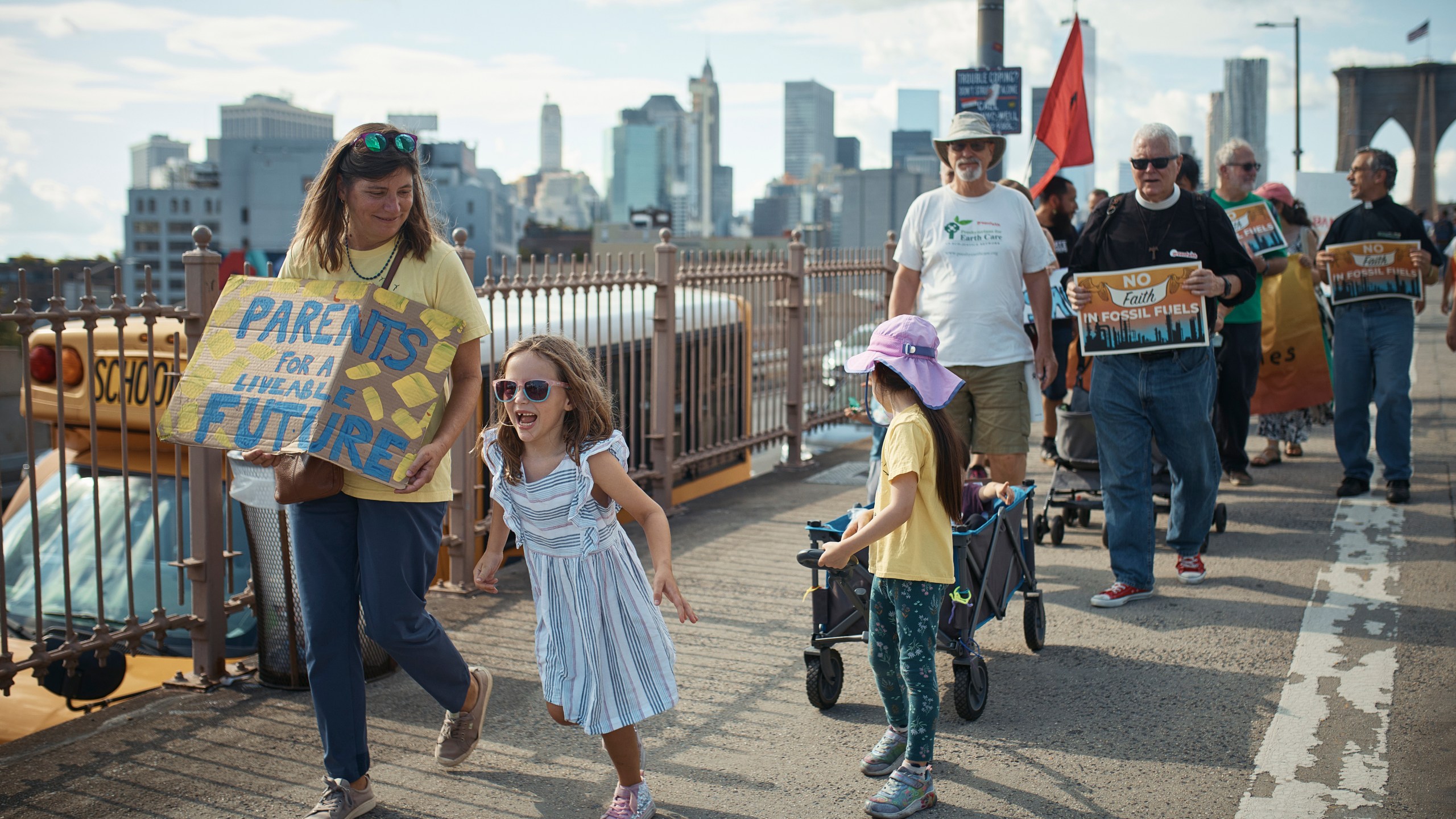 Protesters cross the Brooklyn Bridge during a Youth Climate Strike march to demand an end to the era of fossil fuels, Friday, Sept. 20, 2024, in New York. (AP Photo/Andres Kudacki)