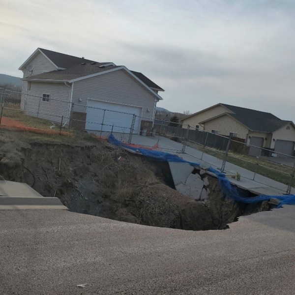 This photo taken April 27, 2022, by Tonya Junker shows a sinkhole in the Hideaway Hills neighborhood near Rapid City, S.D. (Tonya Junker via AP)