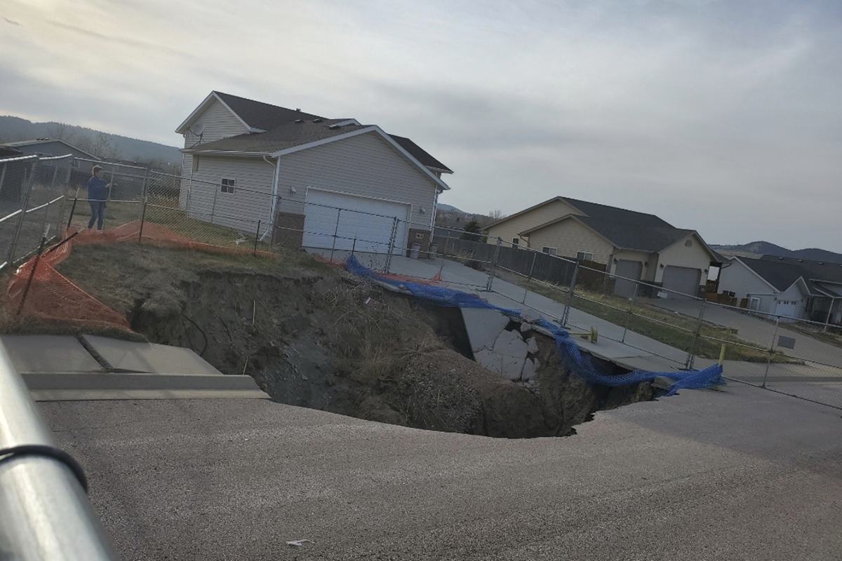 This photo taken April 27, 2022, by Tonya Junker shows a sinkhole in the Hideaway Hills neighborhood near Rapid City, S.D. (Tonya Junker via AP)