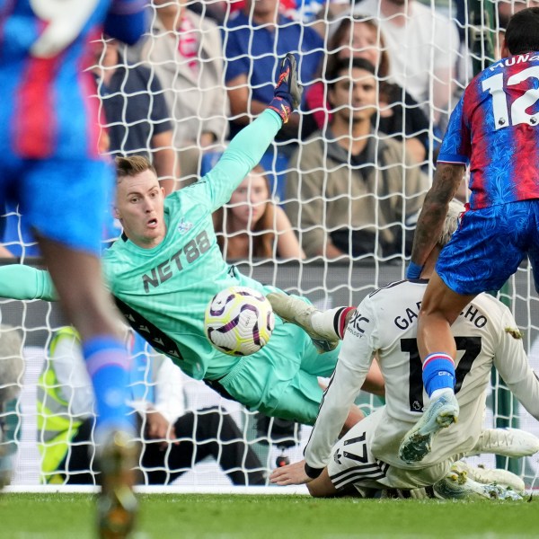 Crystal Palace's goalkeeper Dean Henderson goes for a save in front of Manchester United's Alejandro Garnacho during the English Premier League soccer match between Crystal Palace and Manchester United at Selhurst Park in London, Saturday, Sept. 21, 2023. (AP Photo/Kin Cheung)