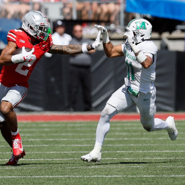 Ohio State receiver Emeka Egbuka, left, tries to stiff arm Marshall defensive back J.J. Roberts during the first half of an NCAA college football game Saturday, Sept. 21, 2024, in Columbus, Ohio. (AP Photo/Jay LaPrete)