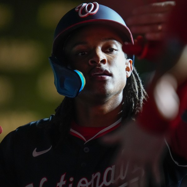 Washington Nationals' CJ Abrams celebrates after scoring on a double from James Wood during the third inning of a baseball game against the Chicago Cubs, Thursday, Sept. 19, 2024, in Chicago. (AP Photo/Erin Hooley)