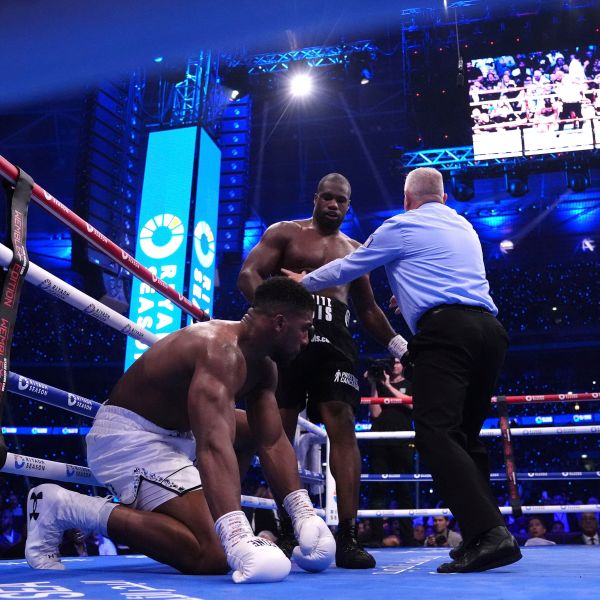 Daniel Dubois, centre, knocks down Anthony Joshua in the IBF World Heavyweight bout at Wembley Stadium, in London, Saturday, Sept. 21, 2024. (Bradley Collyer/PA via AP)