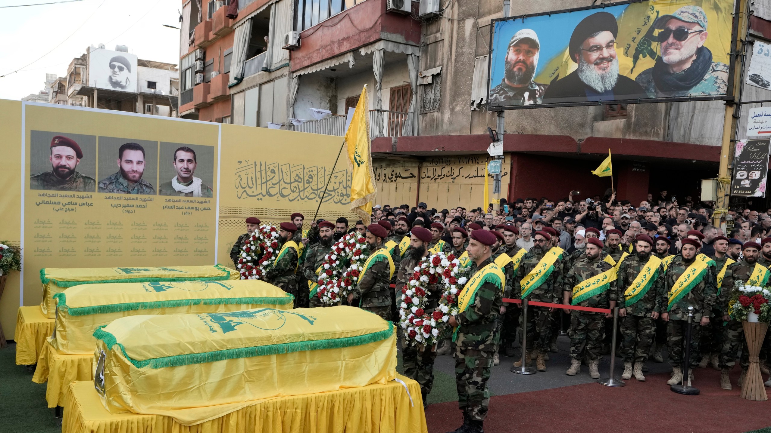 Hezbollah fighters carry wreaths during the funeral procession of their comrades who were killed in Friday's Israeli strike, in the southern suburb of Beirut, Saturday, Sept. 21, 2024. (AP Photo/Bilal Hussein)